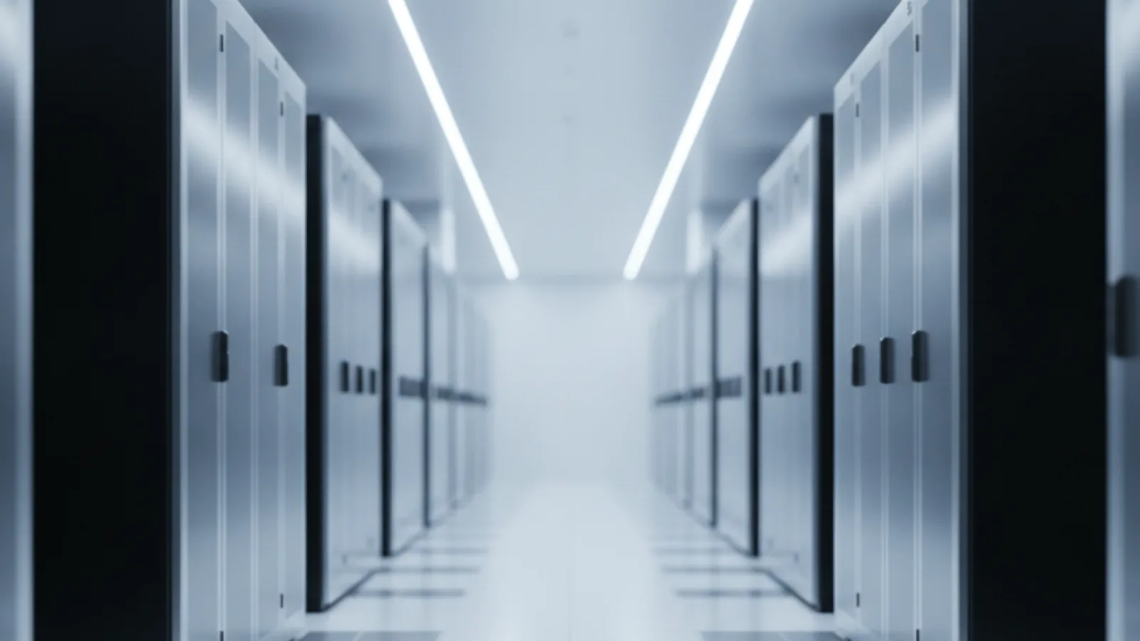 A symmetrical data center hallway with numerous black server cabinets lining both sides, illuminated by bright, cool-white linear ceiling lights.